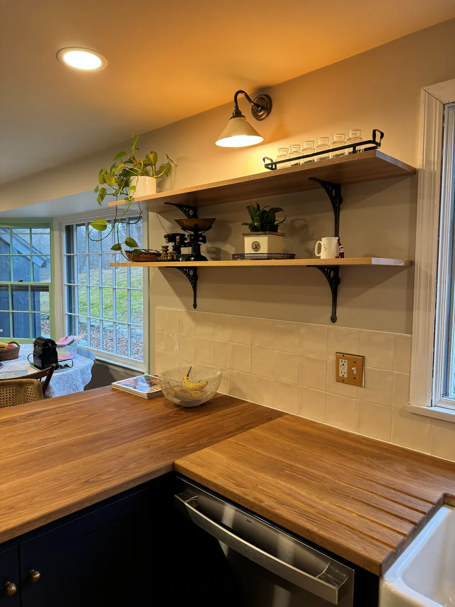 Small kitchen renovation with wood countertops, open shelving, and tile backsplash