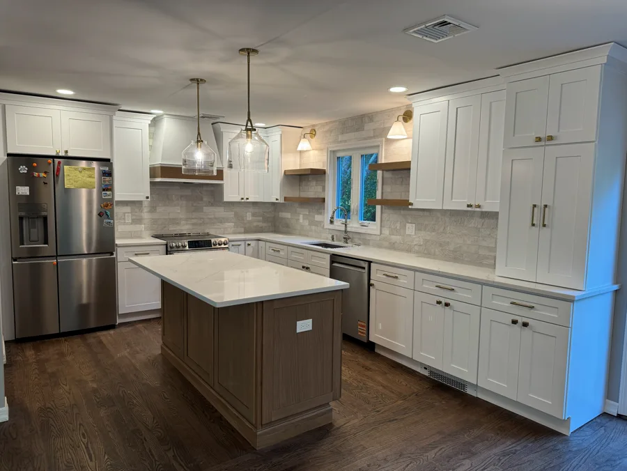 Kitchen cabinets and island with light finishes and detailed installation