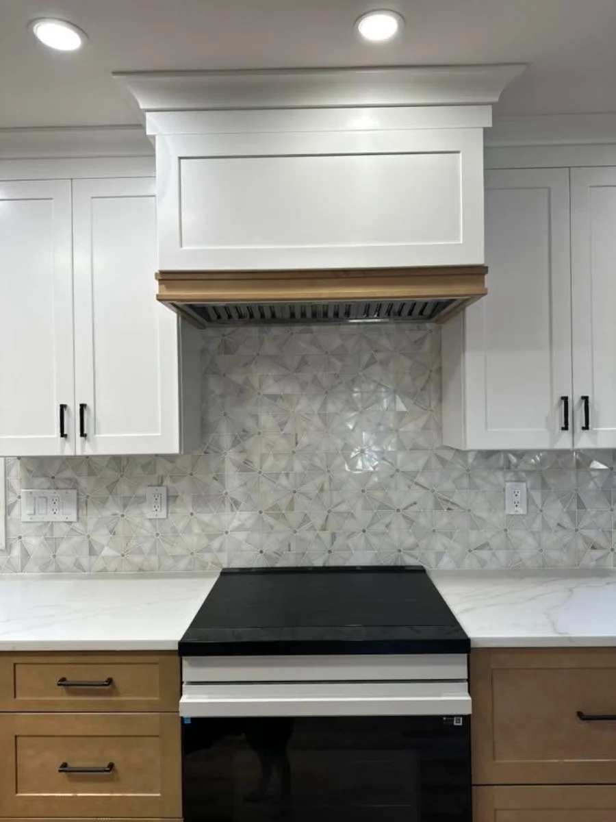 Residential kitchen backsplash with custom hood surround and cabinet details